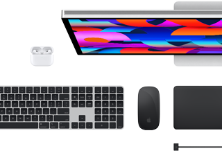 Top view of Mac accessories: Studio Display, AirPods, Magic Keyboard, Magic Mouse, and Magic Trackpad