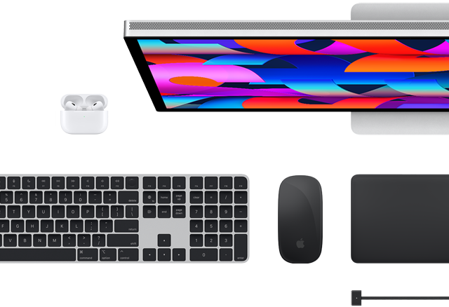 Top view of select Mac accessories: Studio Display, Magic Keyboard, Magic Mouse, Magic Trackpad, AirPods, and MagSafe charging cable